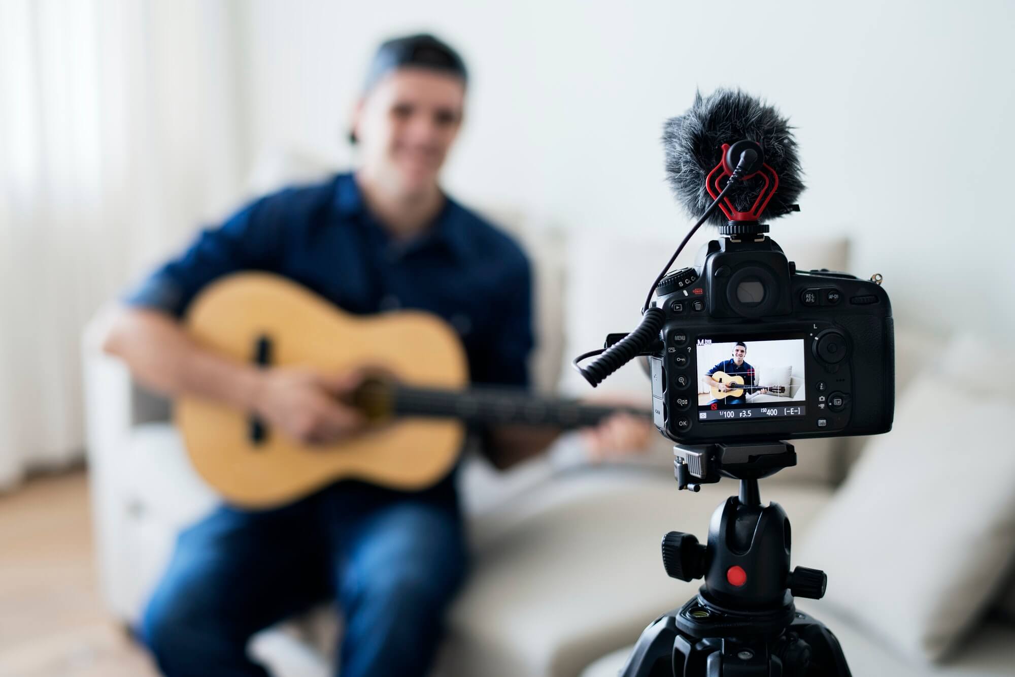 Male vlogger recording music related broadcast at home